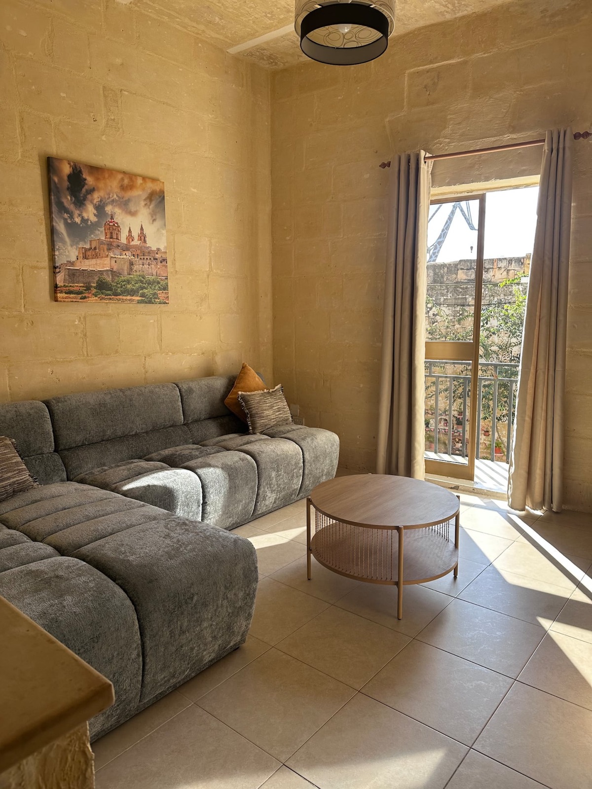 Bright living room with sofa and natural light in the Senglea townhouse