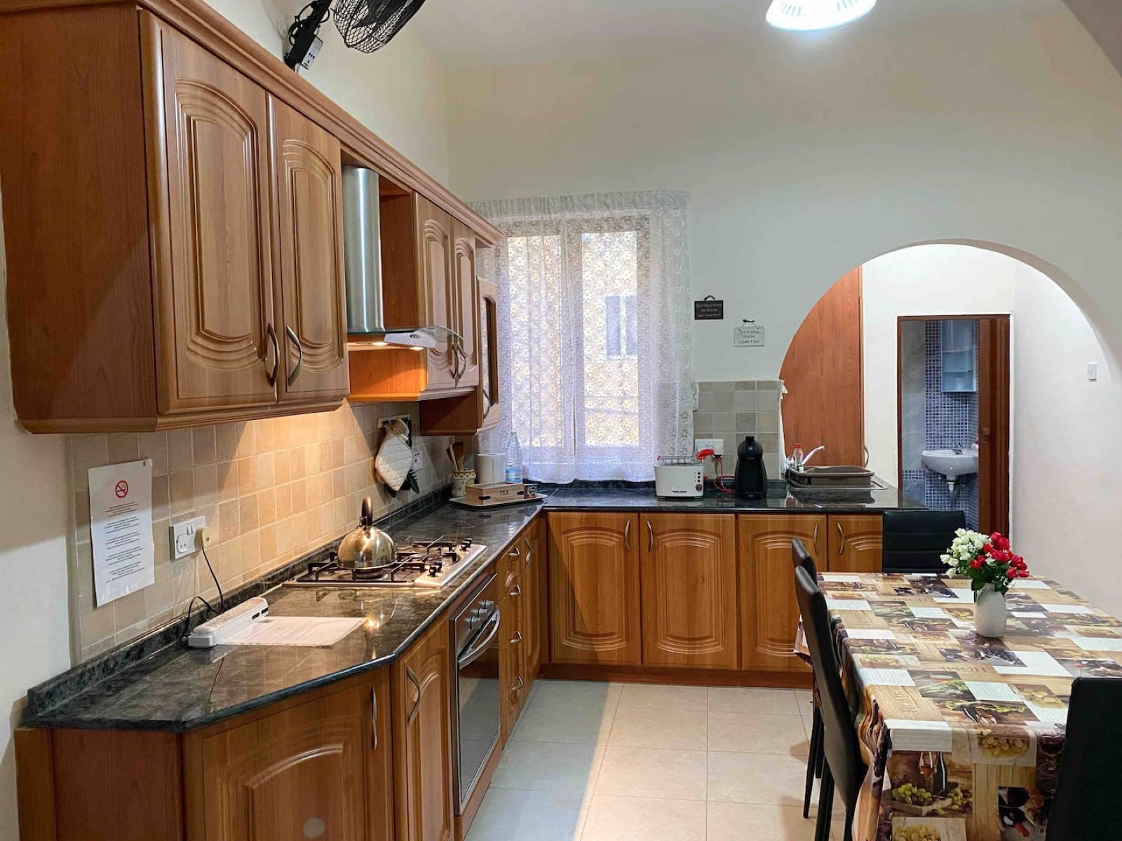 Full kitchen with fridge, gas hob, oven and toaster