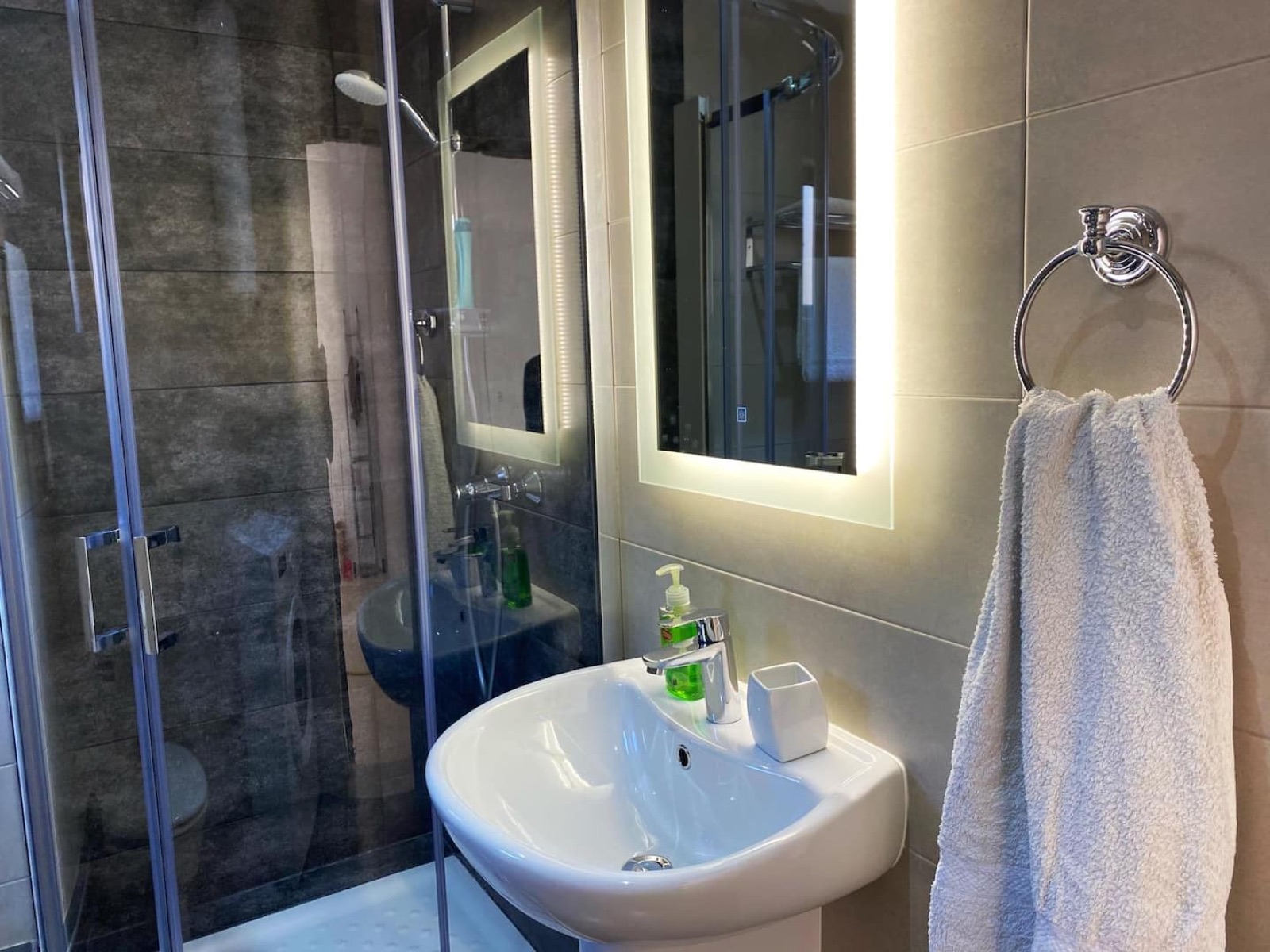 Bathroom with shower and towel rail