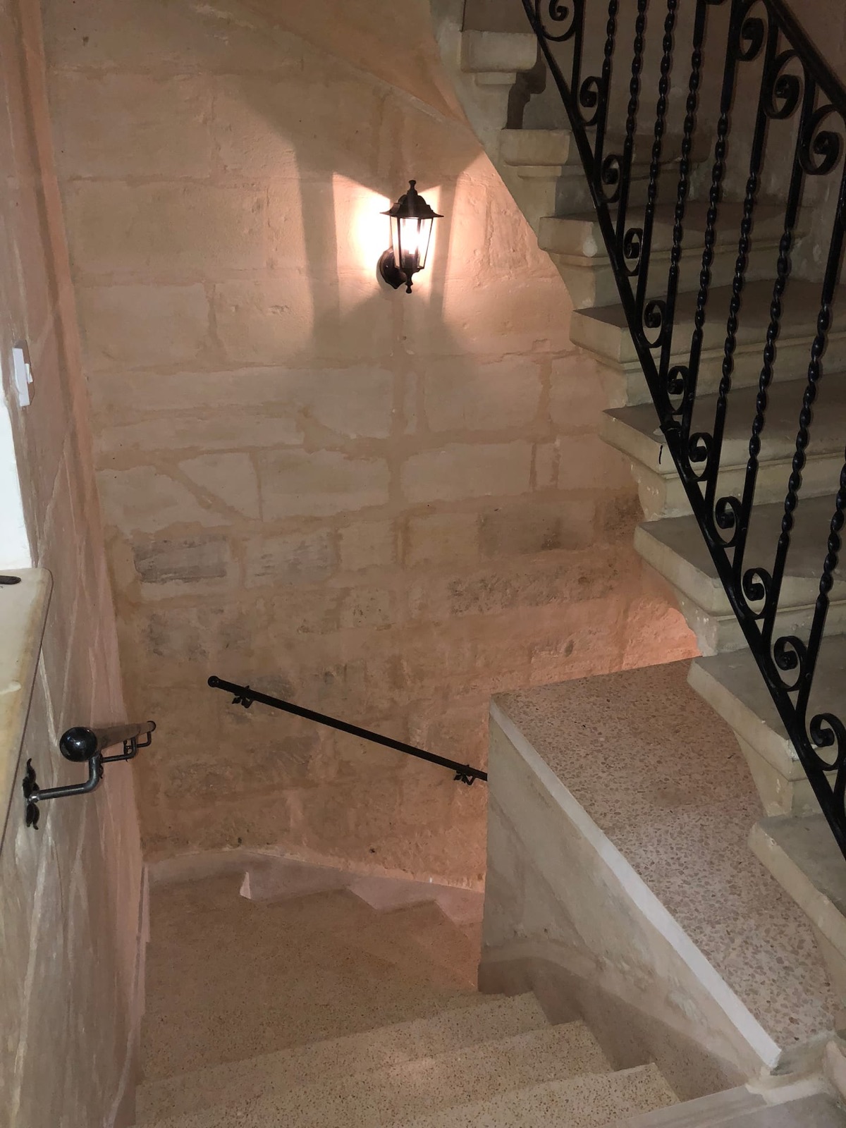 Traditional Maltese stone staircase with wrought-iron balustrade and hand railings inside Senglea Harbour View